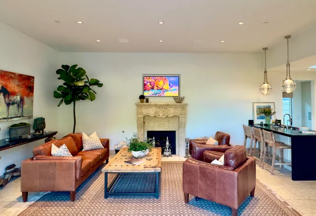 a living room with furniture a fireplace and a flat screen tv