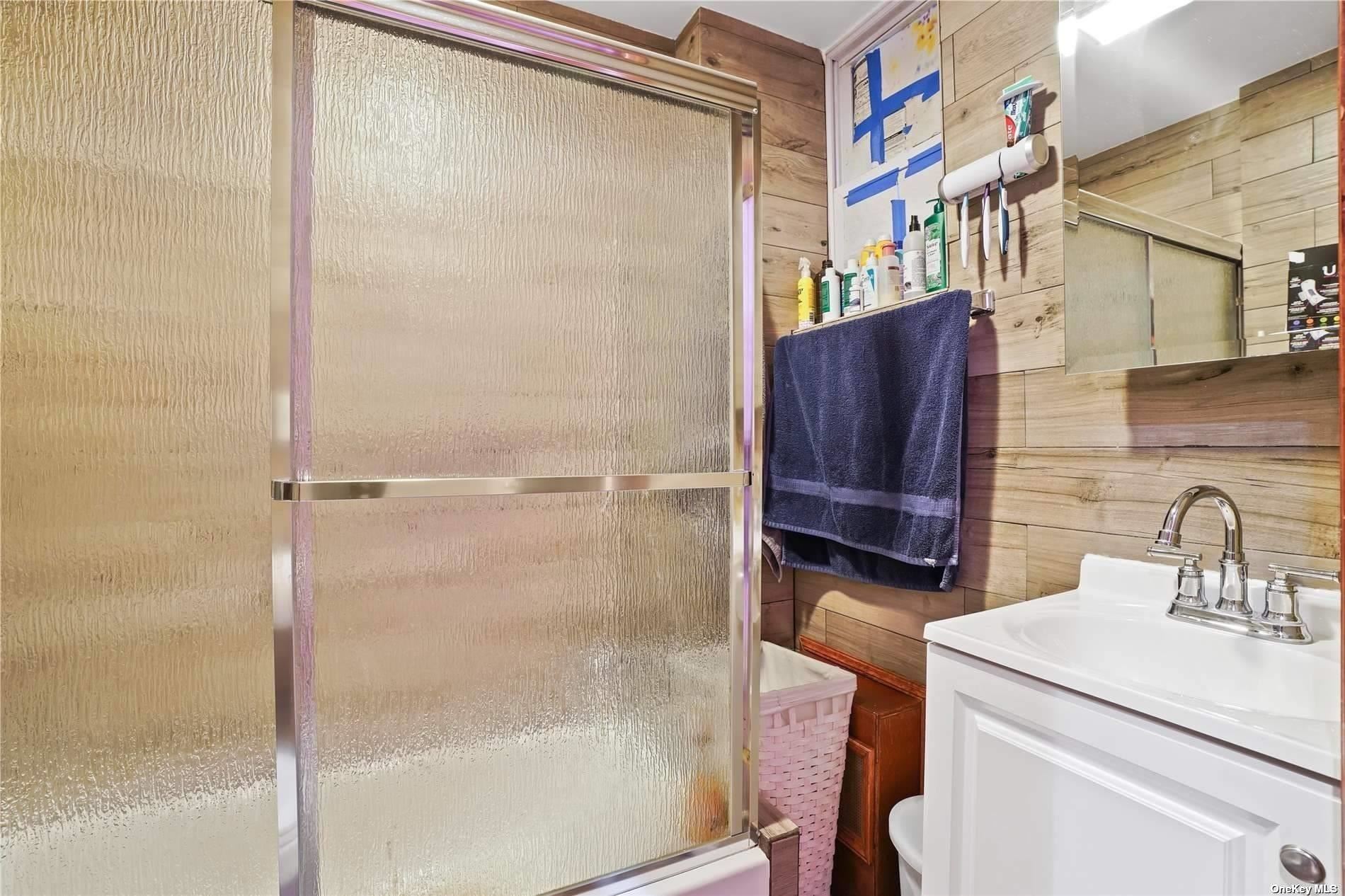 18-11 Centre Street Queens, NY 11385 - Photo 15 of 27 a bathroom with a sink a toilet and shower