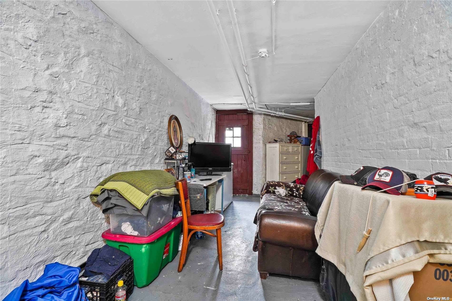 18-11 Centre Street Queens, NY 11385 - Photo 22 of 27 a living room with furniture a couch and a flat screen tv
