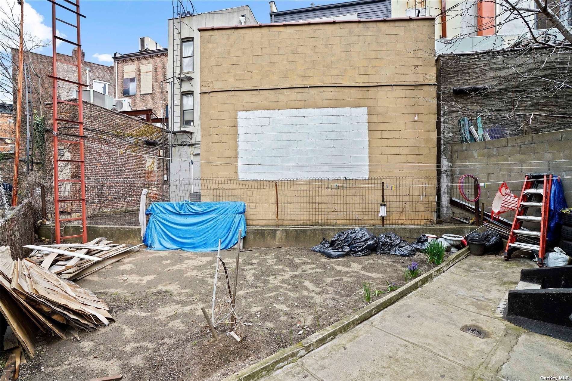 18-11 Centre Street Queens, NY 11385 - Photo 27 of 27 a view of a patio with chair and tables back yard of the house