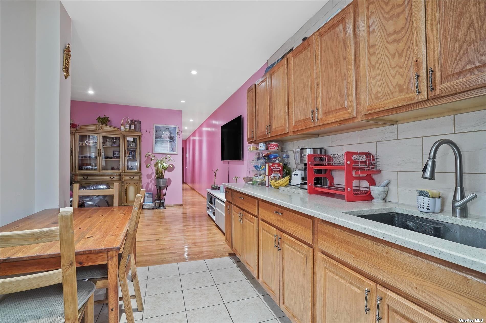 18-11 Centre Street Queens, NY 11385 - Photo 8 of 27 a kitchen with stainless steel appliances a sink dishwasher and cabinets with wooden floor