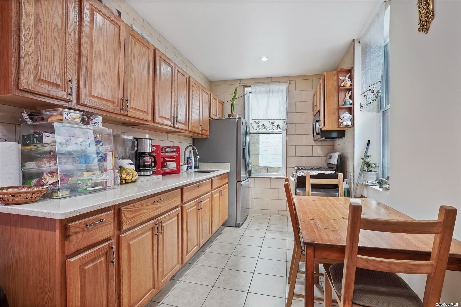 18-11 Centre Street Queens, NY 11385 - Photo 9 of 27 a kitchen with stainless steel appliances granite countertop a sink and cabinets