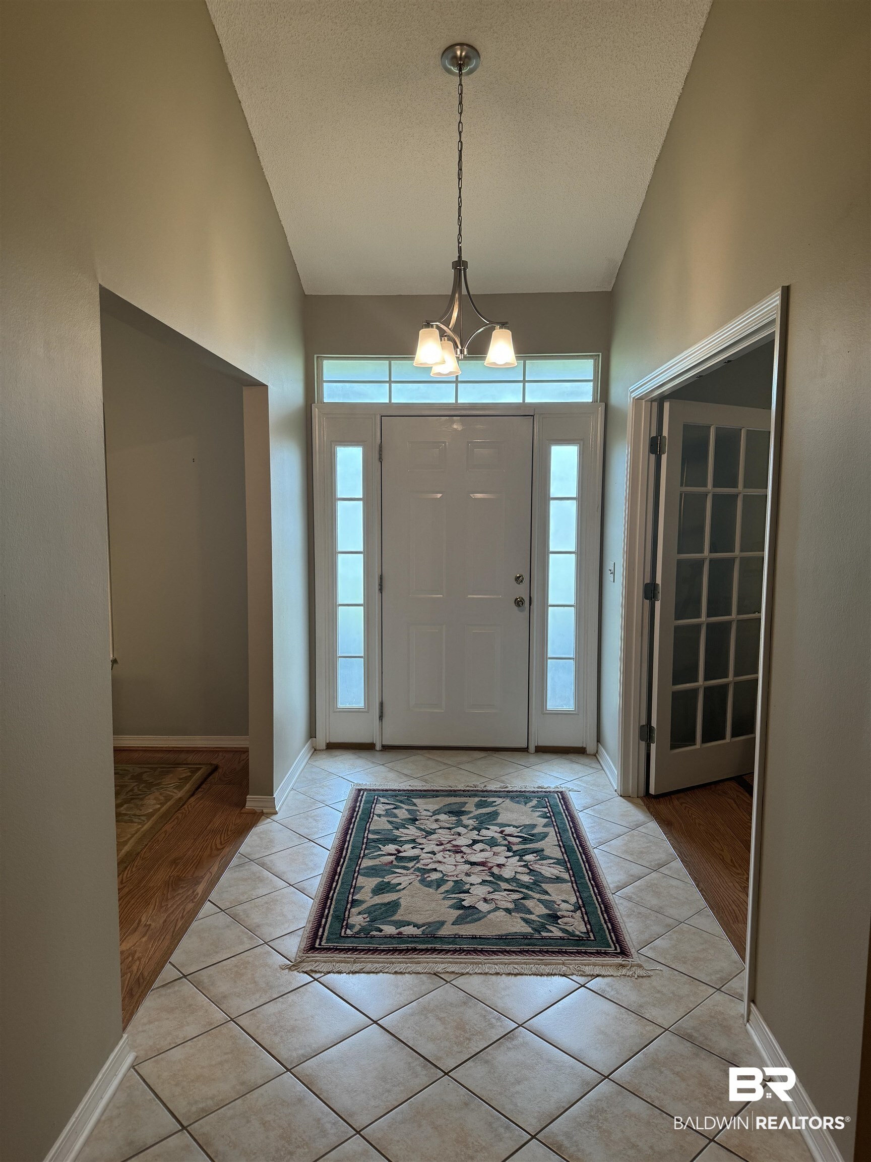 9139 Clubhouse Drive Foley, AL 36535 - Photo 9 of 30 Foyer entrance featuring a notable chandelier, a wealth of natural light, and light wood-type flooring