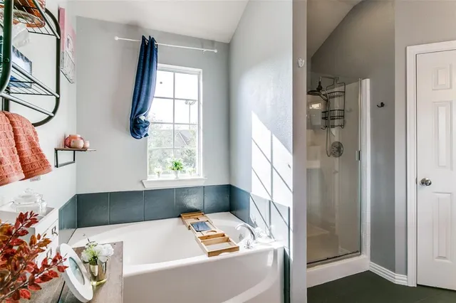 a kitchen with stainless steel appliances kitchen island granite countertop a refrigerator a stove a sink a dining table and chairs with wooden floor