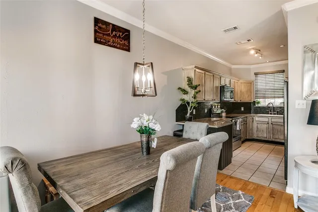 a kitchen with stainless steel appliances wooden cabinets sink and a microwave