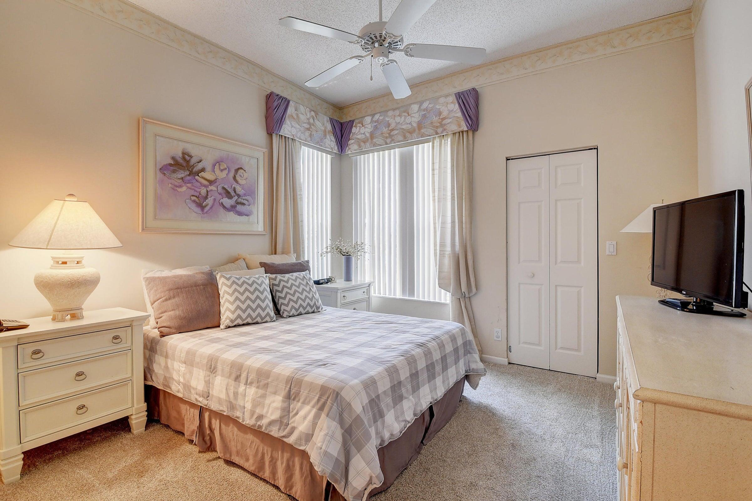 7725 Rockford Road Boynton Beach, FL 33472 - Photo 17 of 47 a bedroom with a bed and a flat screen tv