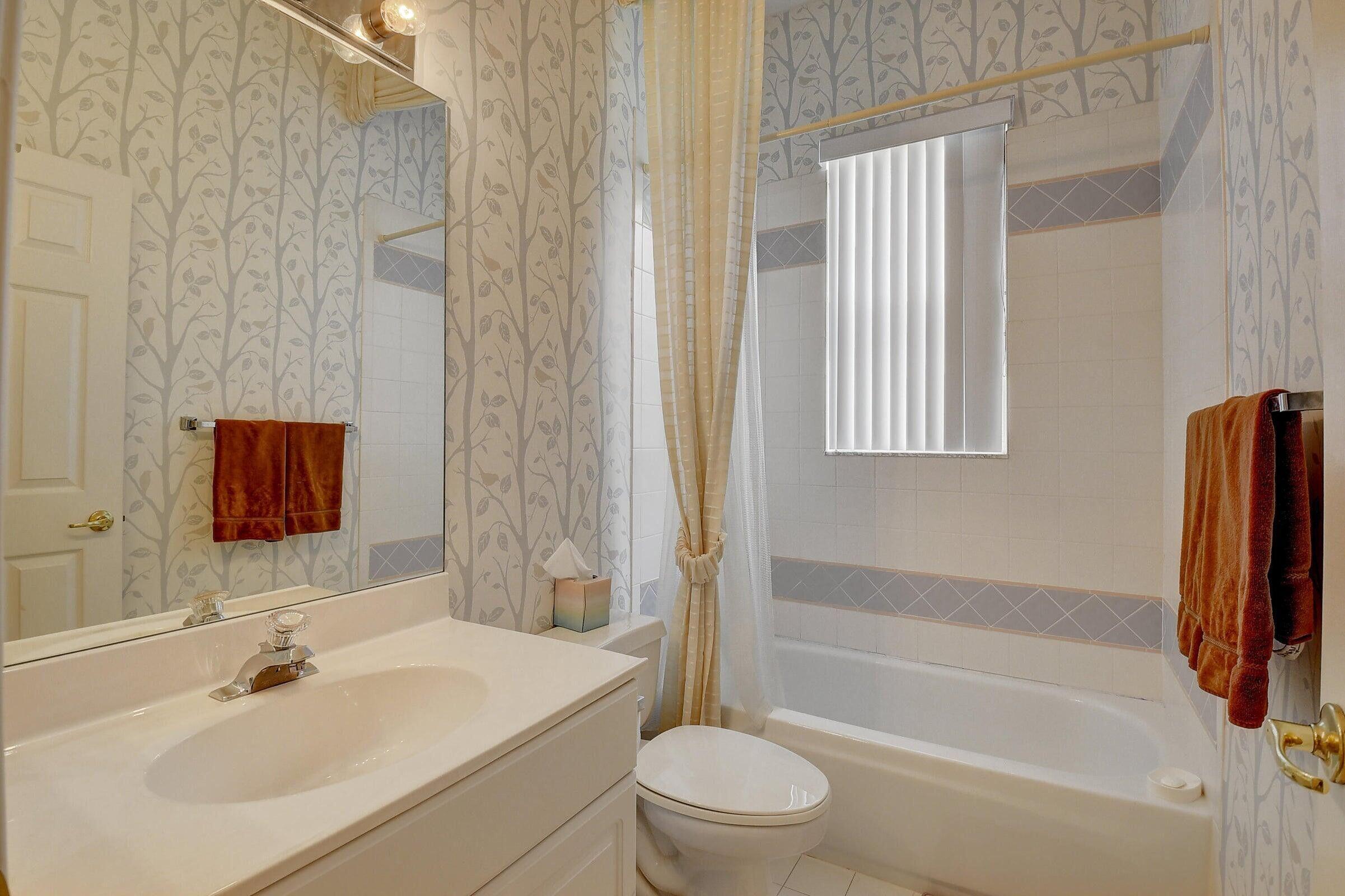 7725 Rockford Road Boynton Beach, FL 33472 - Photo 18 of 47 a bathroom with a sink toilet and shower