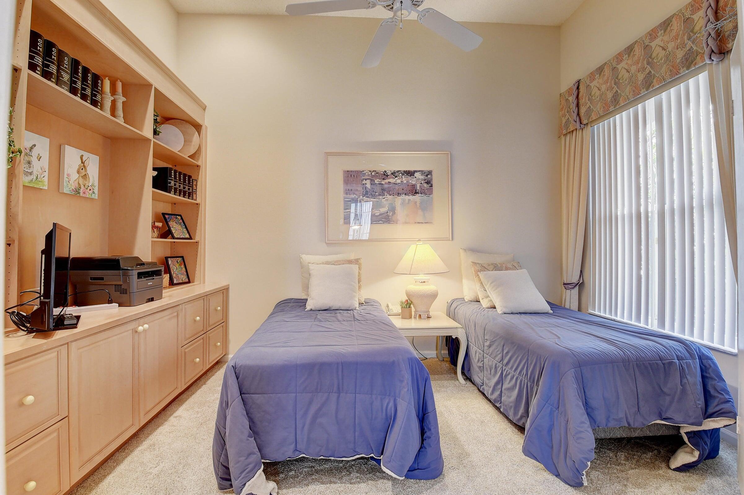 7725 Rockford Road Boynton Beach, FL 33472 - Photo 19 of 47 a spacious bedroom with two beds and a flat screen tv