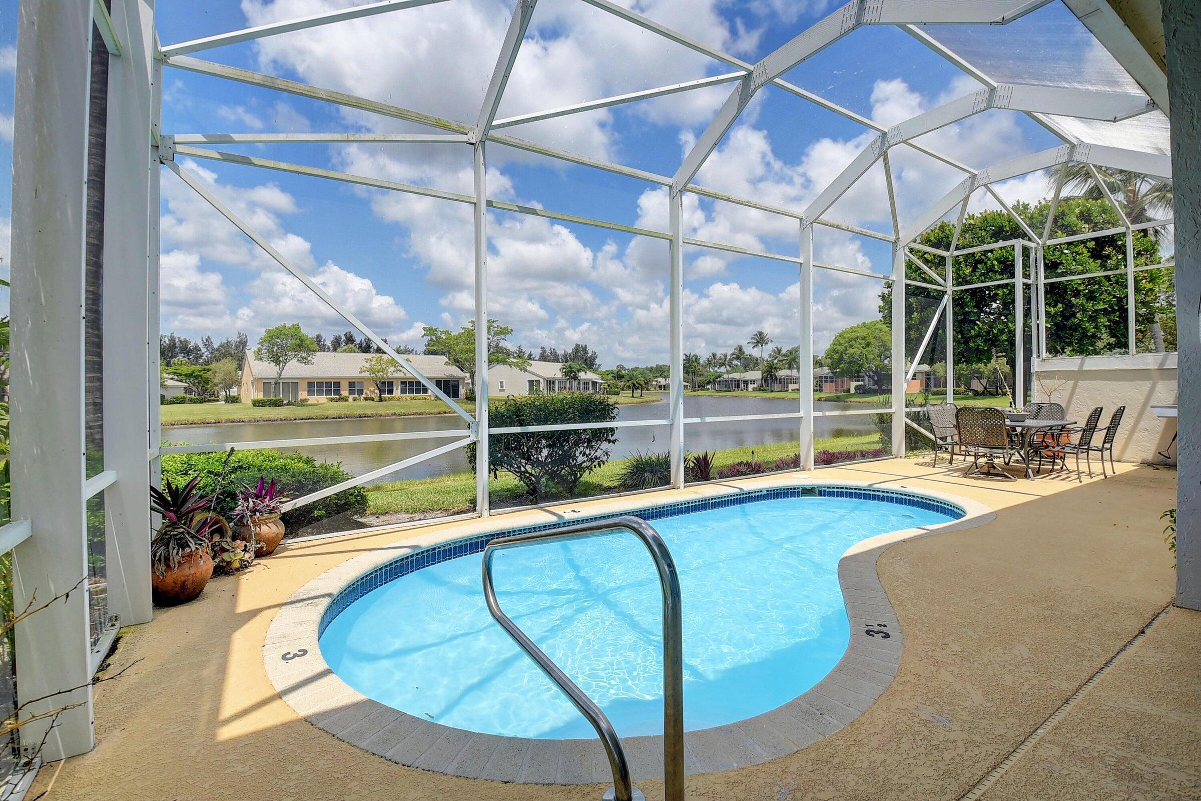 7725 Rockford Road Boynton Beach, FL 33472 - Photo 21 of 47 a view of a swimming pool with a patio