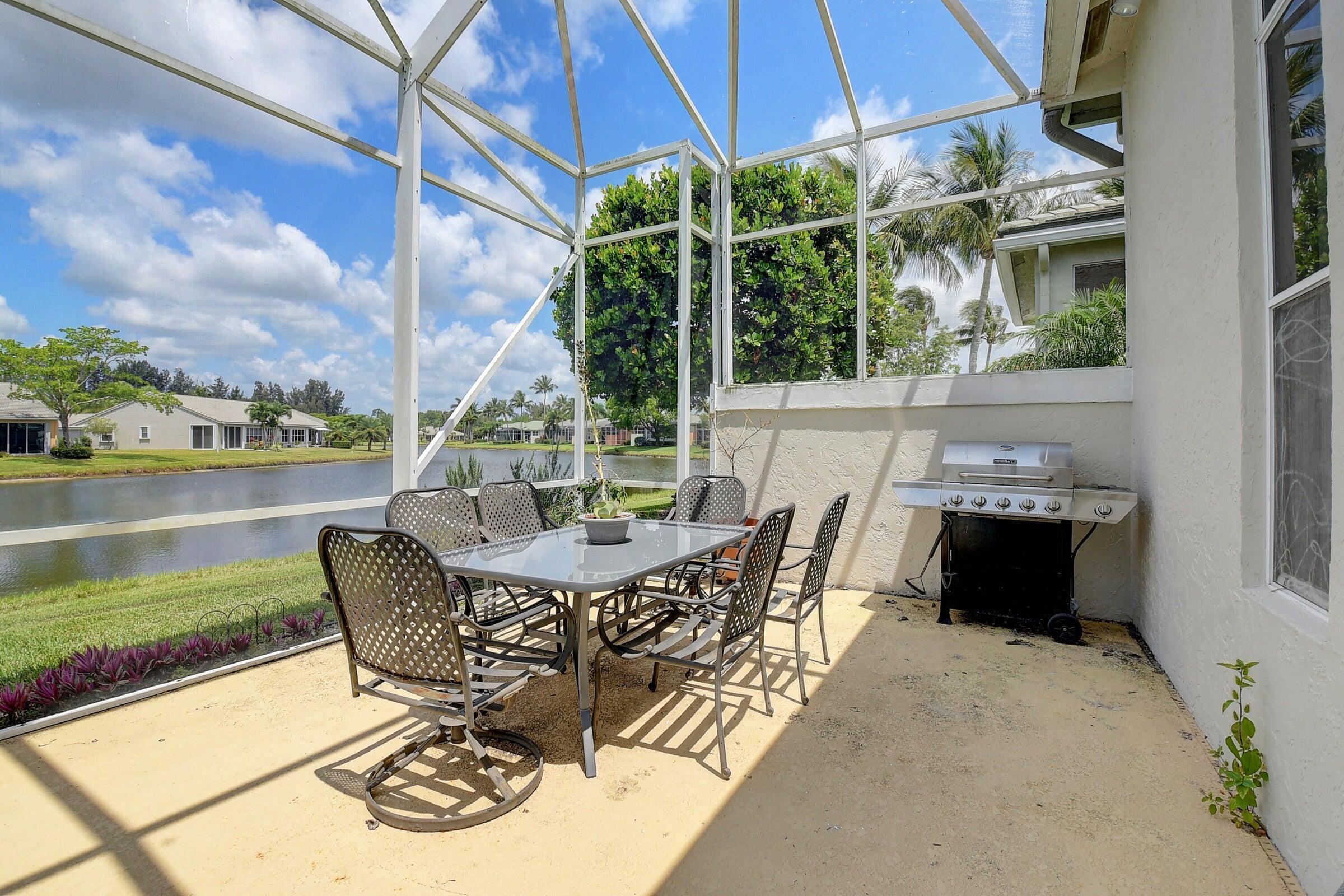 7725 Rockford Road Boynton Beach, FL 33472 - Photo 24 of 47 a view of a patio with table and chairs