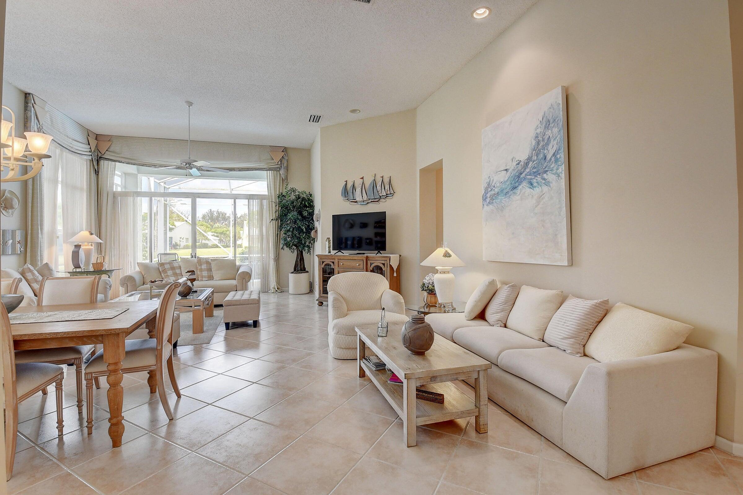 7725 Rockford Road Boynton Beach, FL 33472 - Photo 6 of 47 a living room with furniture a fireplace and a flat screen tv