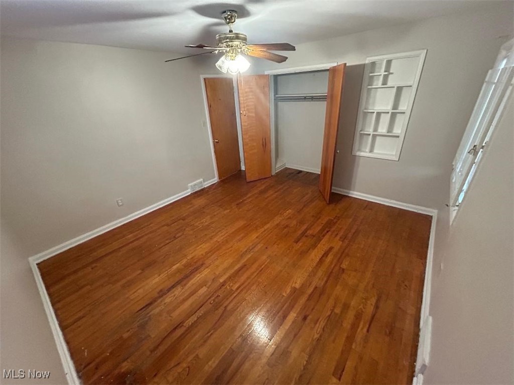 1130 Carver Road Cleveland, OH 44112 - Photo 15 of 32 Bedroom 2 featuring closets, hardwood / wood-style floors, and ceiling fan