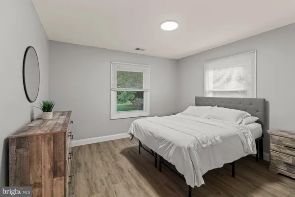 a bed sitting in a bedroom next to a window