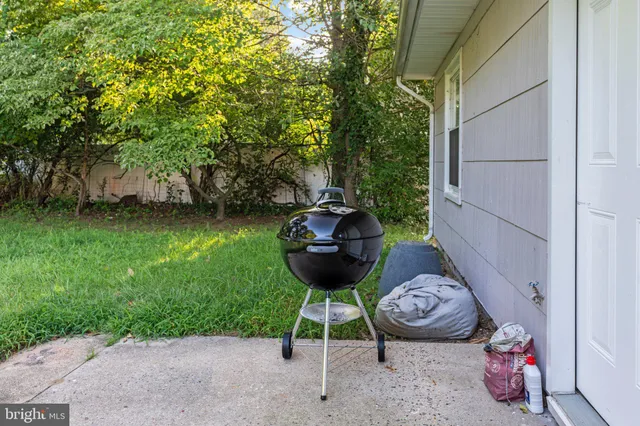 a view of a backyard with table and chairs