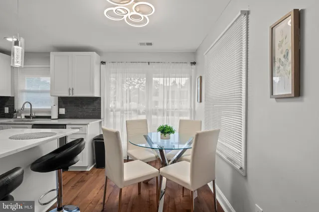 a view of a dining room with furniture and wooden floor