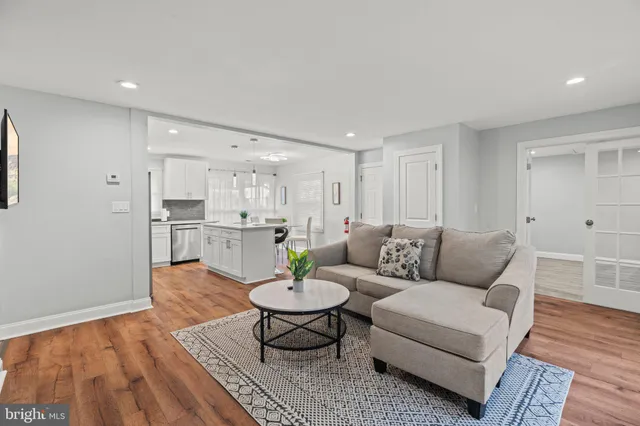 a living room with furniture and view of kitchen