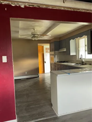 a kitchen with granite countertop a sink and a stove