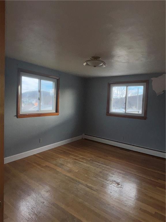 306 West 1st Street Rural Valley, PA 16249 - Photo 9 of 12 a view of an empty room with wooden floor and a window
