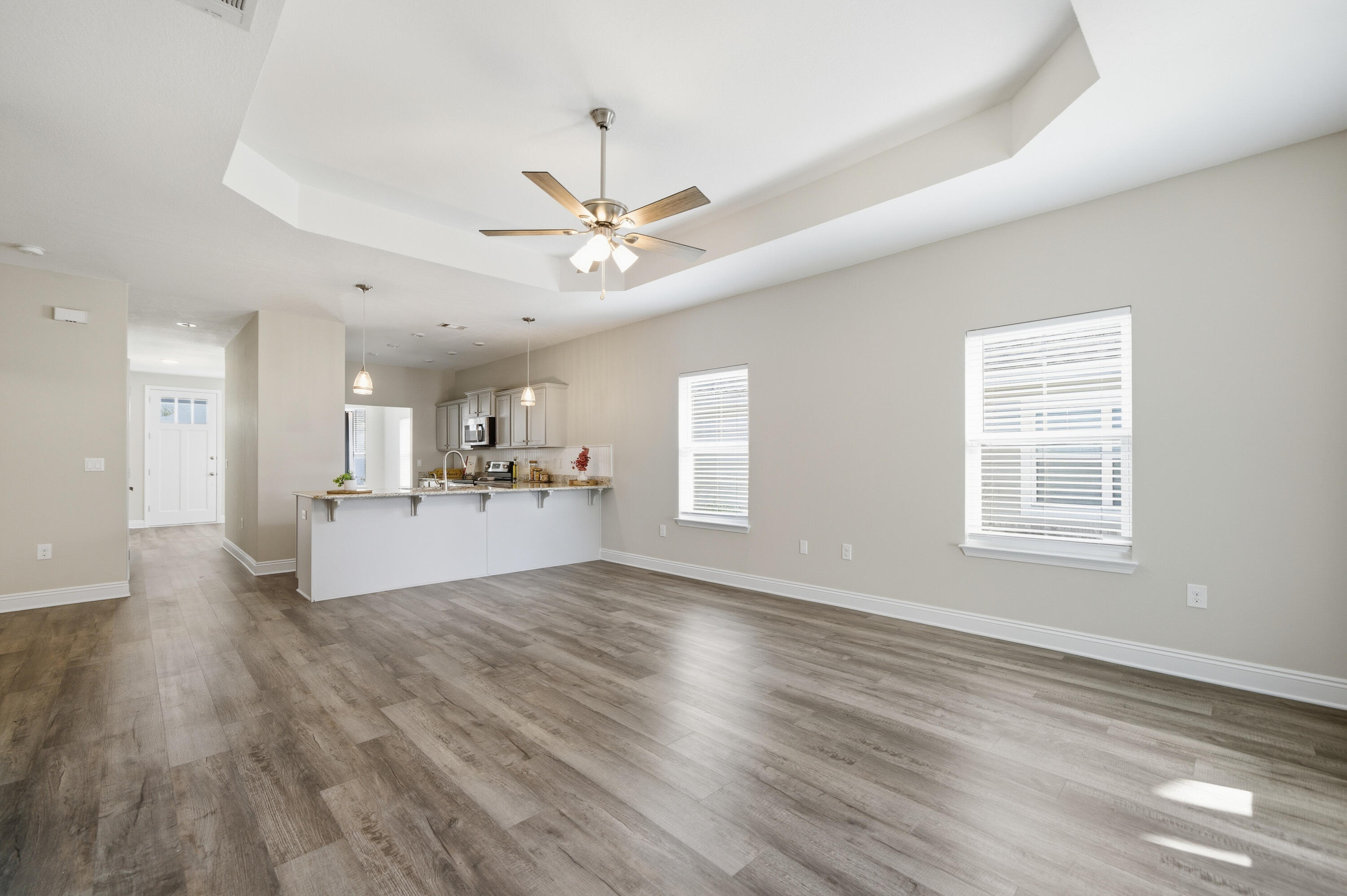 802 Marquis Way Freeport, FL 32439 - Photo 11 of 43 a view of a livingroom with a furniture wooden floor and a ceiling fan