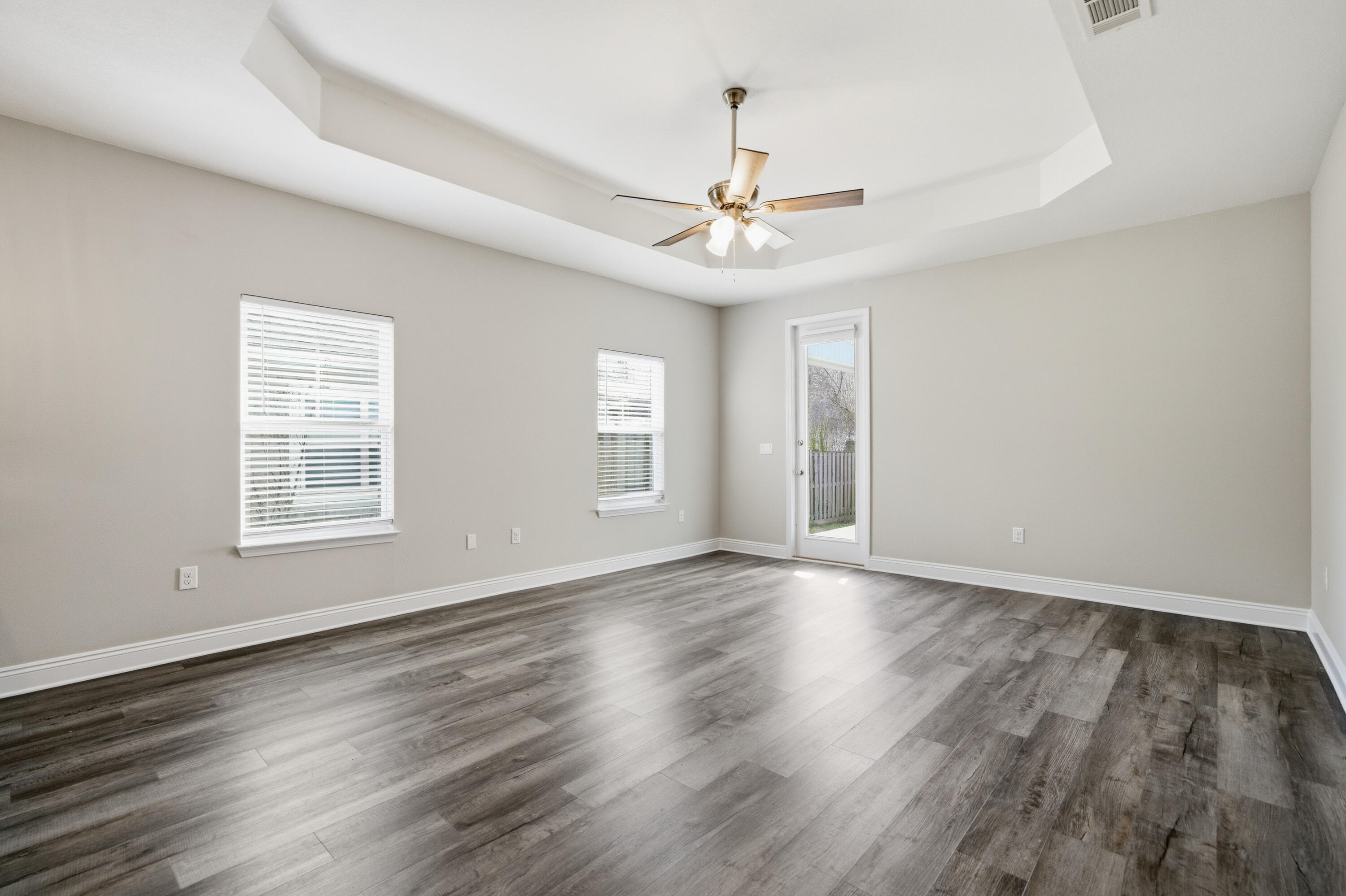 802 Marquis Way Freeport, FL 32439 - Photo 14 of 43 a view of an empty room with wooden floor and a window