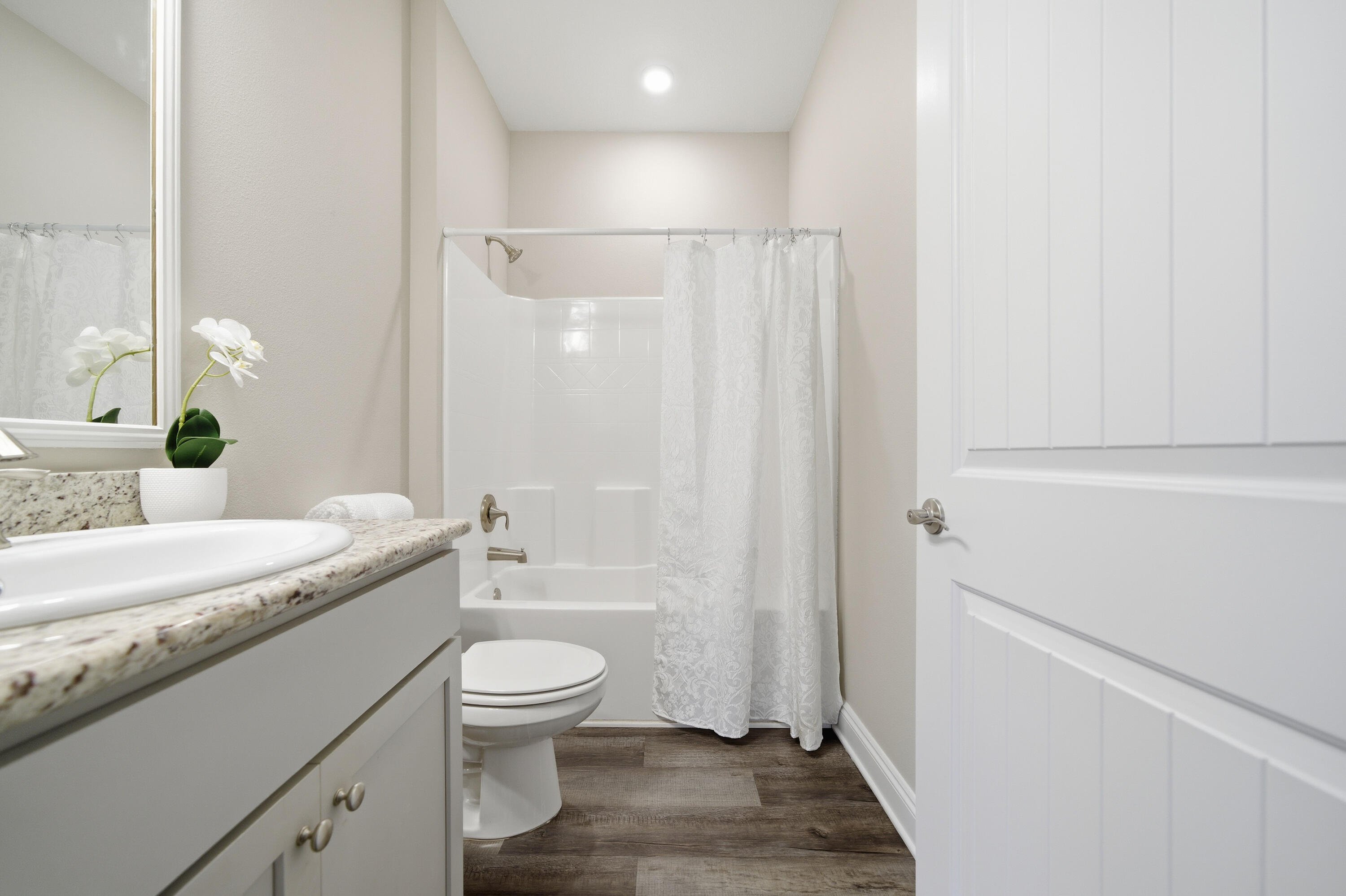 802 Marquis Way Freeport, FL 32439 - Photo 15 of 43 a bathroom with a granite countertop sink a toilet and shower