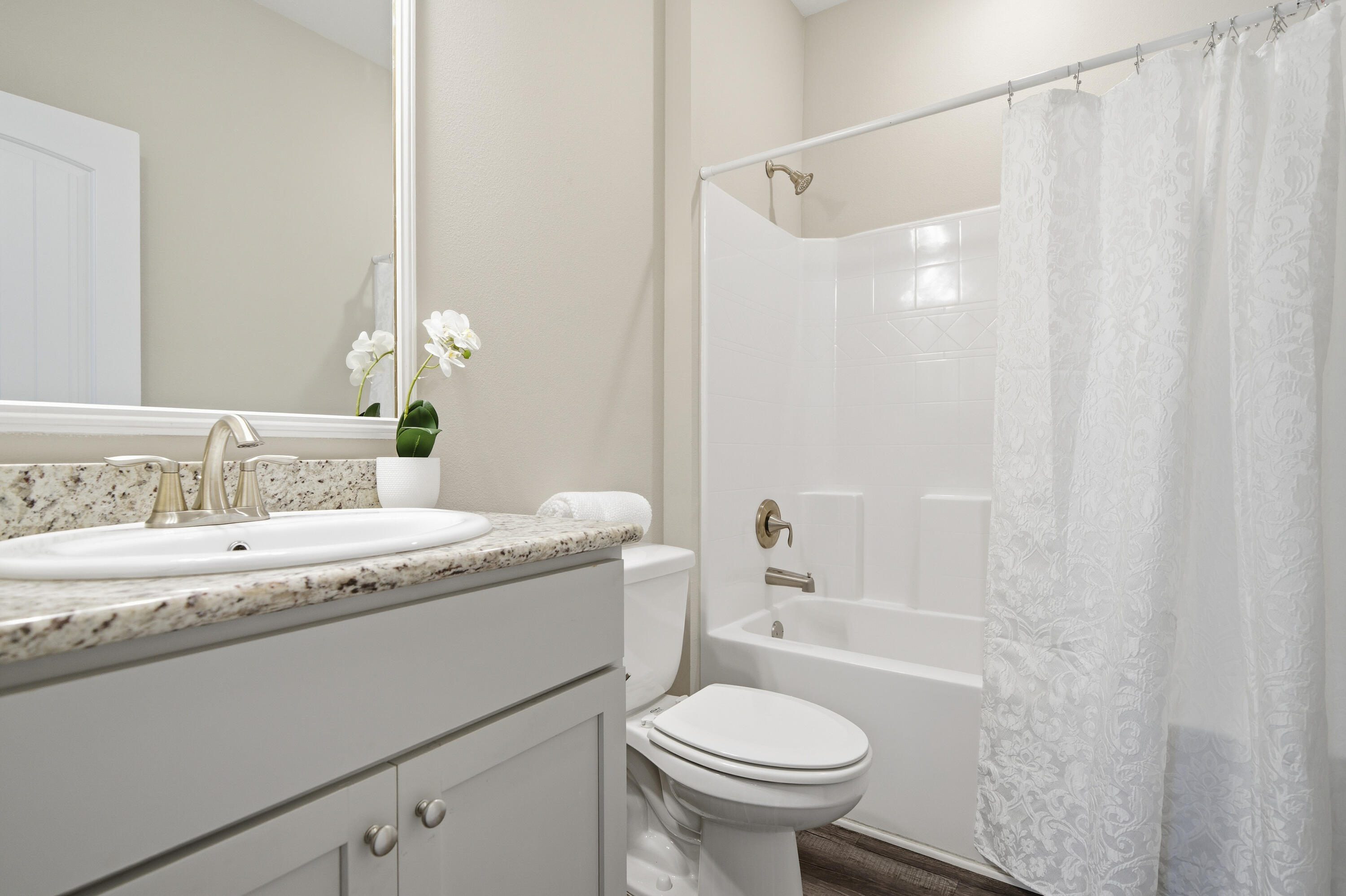 802 Marquis Way Freeport, FL 32439 - Photo 16 of 43 a bathroom with a granite countertop sink and a mirror