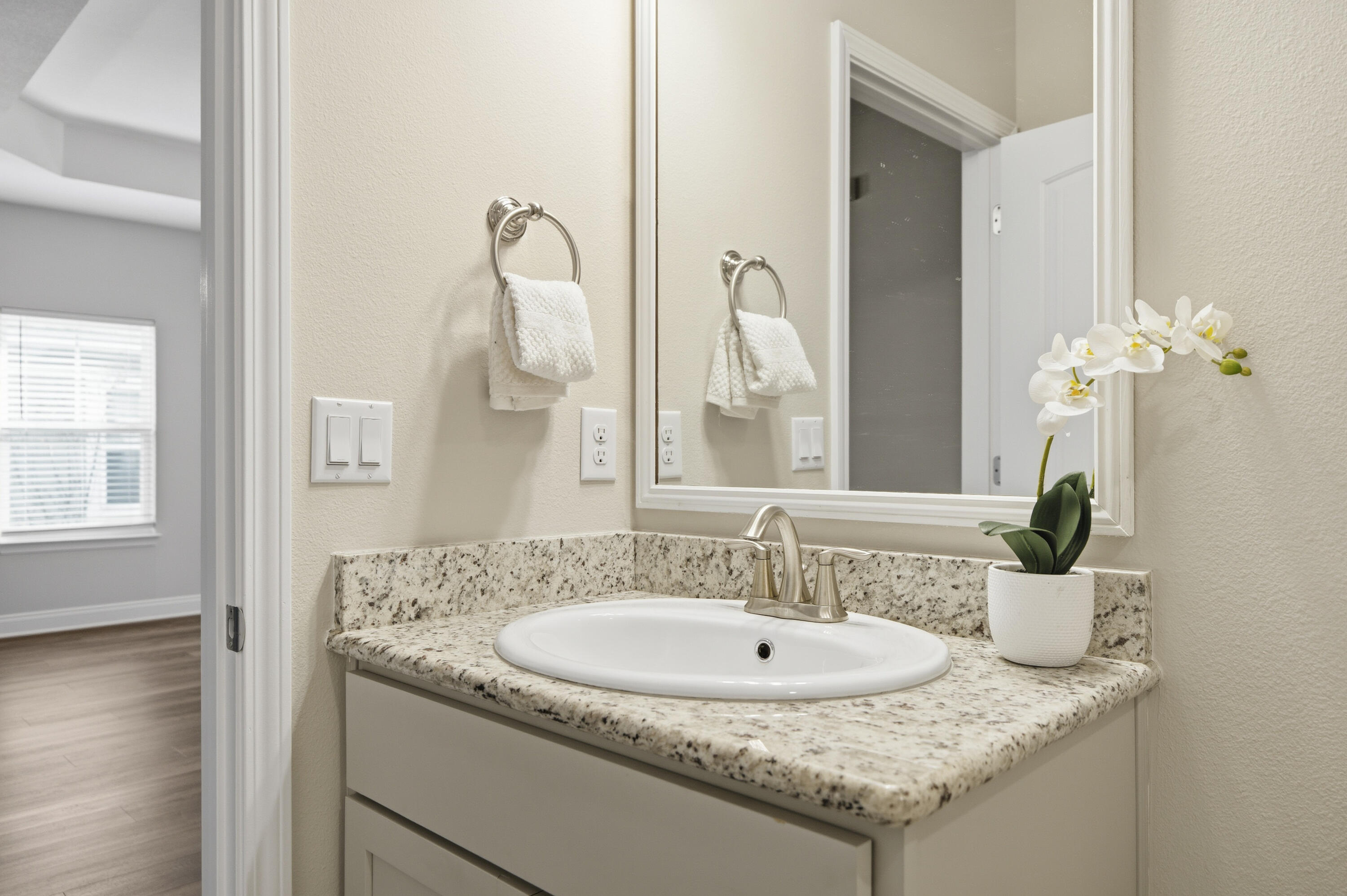 802 Marquis Way Freeport, FL 32439 - Photo 17 of 43 a bathroom with a granite countertop sink and a mirror