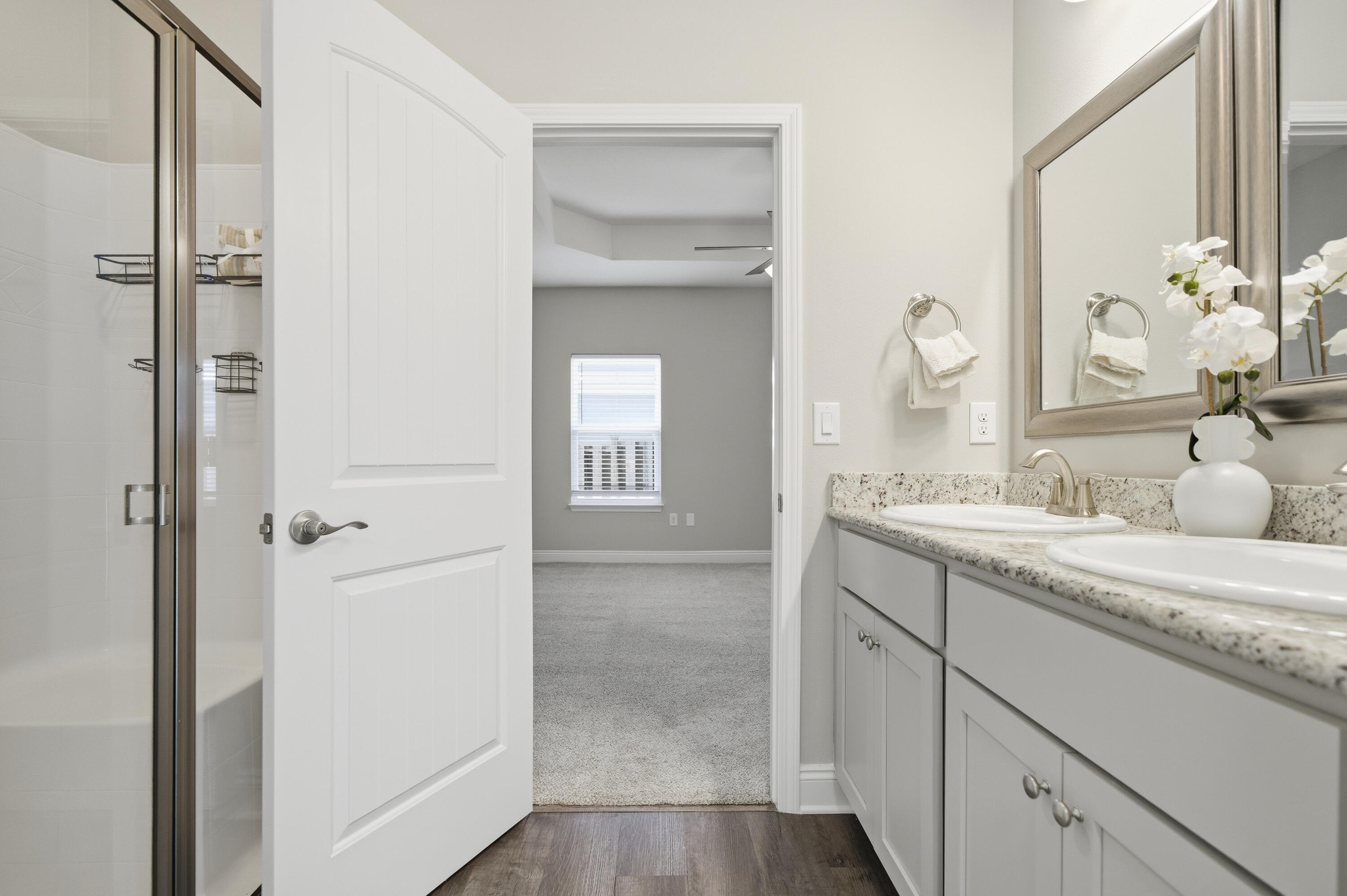 802 Marquis Way Freeport, FL 32439 - Photo 20 of 43 a en suite bathroom with a granite countertop sink mirror and a shower