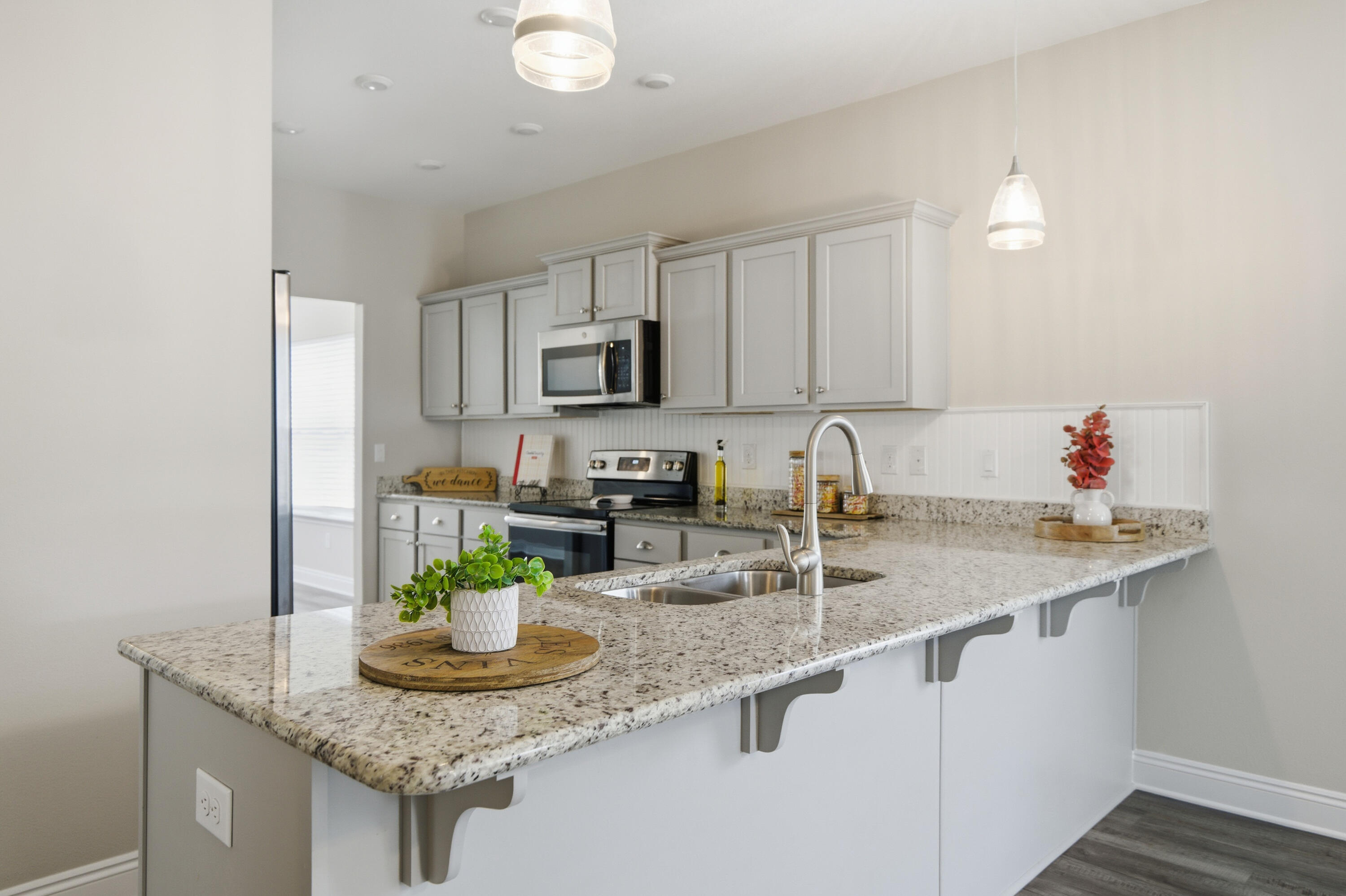 802 Marquis Way Freeport, FL 32439 - Photo 3 of 43 a kitchen with stainless steel appliances granite countertop a sink a stove and a white center island
