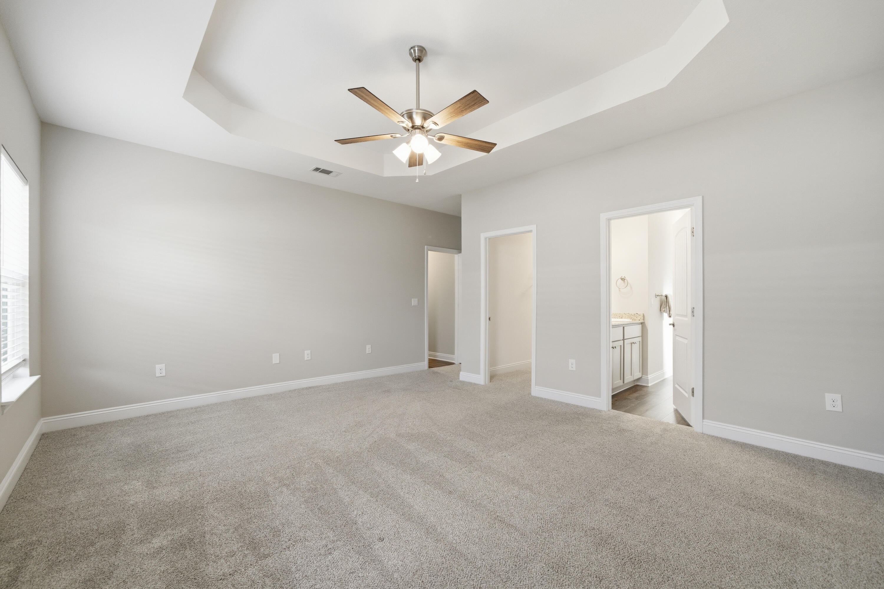802 Marquis Way Freeport, FL 32439 - Photo 33 of 43 an empty room with chandelier fan and windows