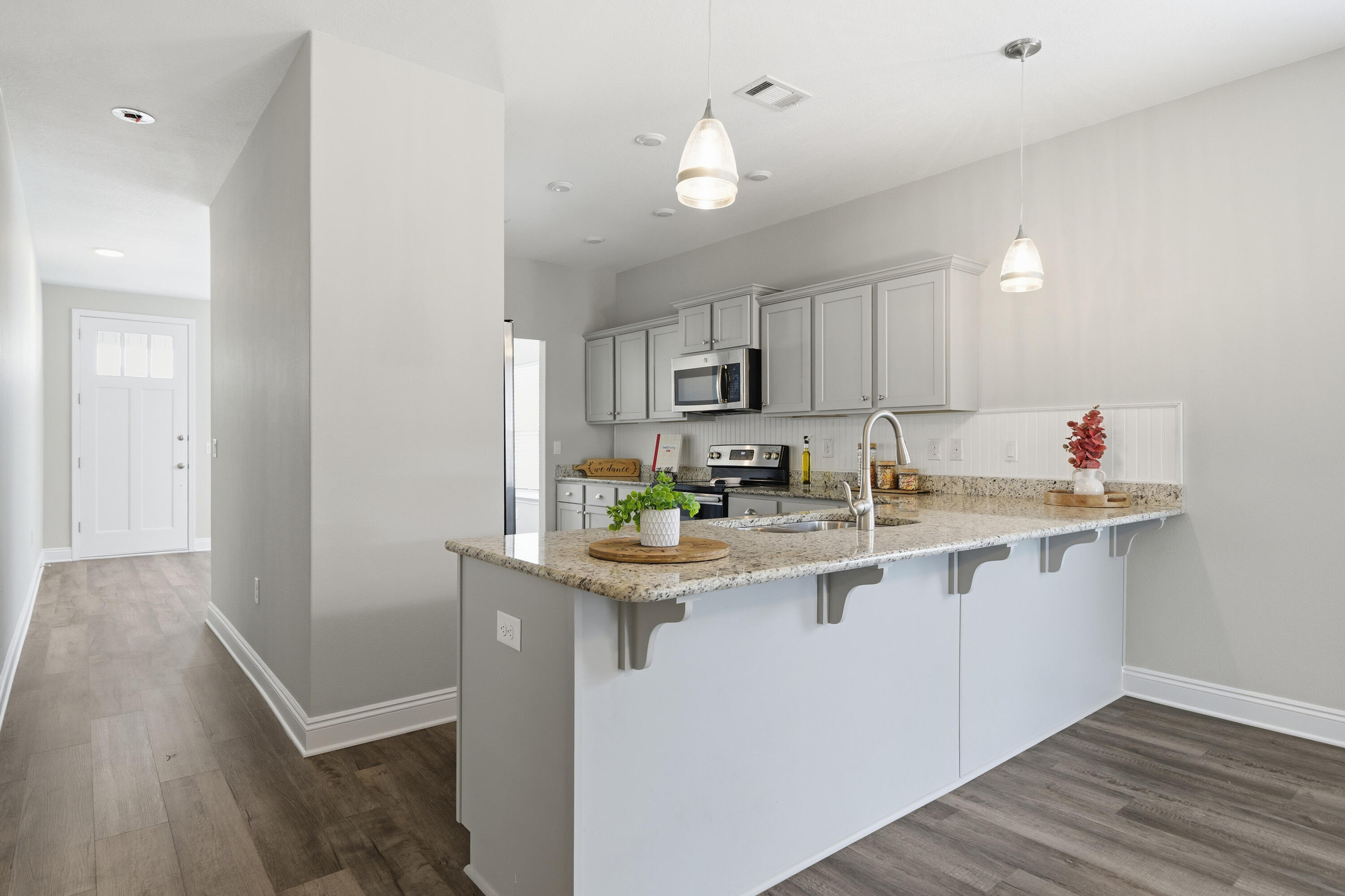 802 Marquis Way Freeport, FL 32439 - Photo 4 of 43 a kitchen with stainless steel appliances granite countertop a sink and cabinets