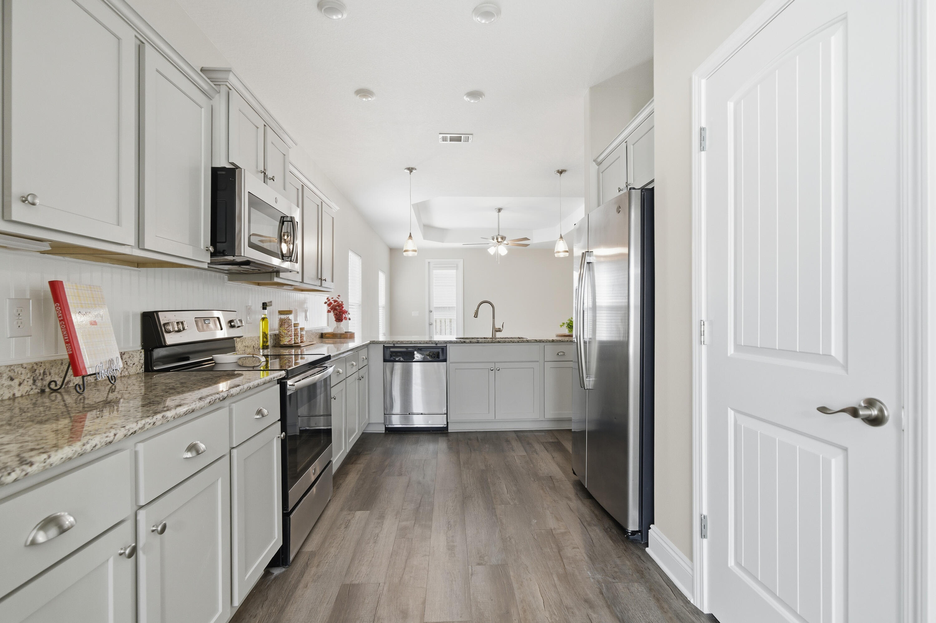 802 Marquis Way Freeport, FL 32439 - Photo 5 of 43 a large kitchen with stainless steel appliances granite countertop a lot of counter space and wooden floor