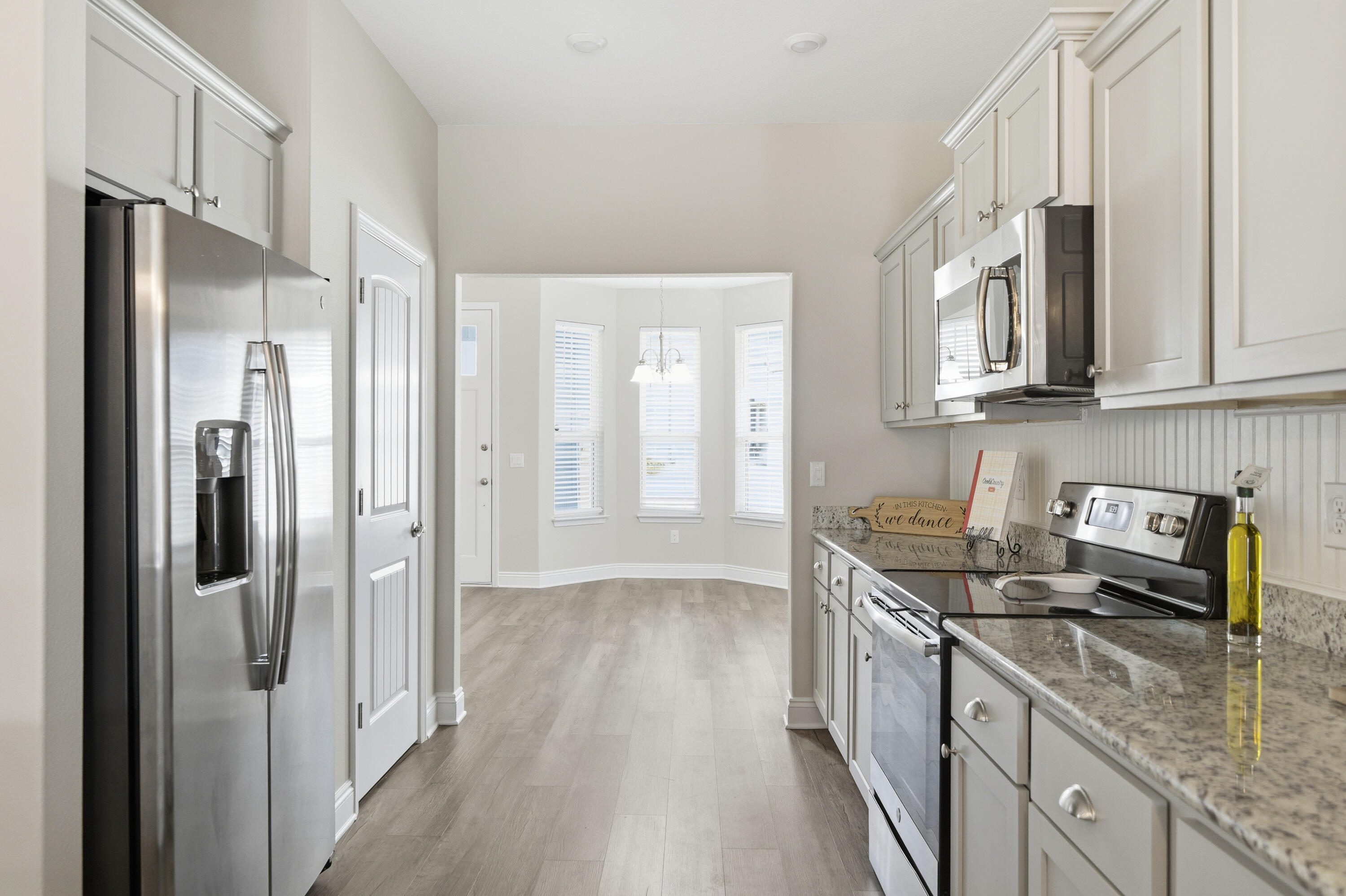 802 Marquis Way Freeport, FL 32439 - Photo 7 of 43 a kitchen with stainless steel appliances granite countertop a refrigerator a sink and white cabinets