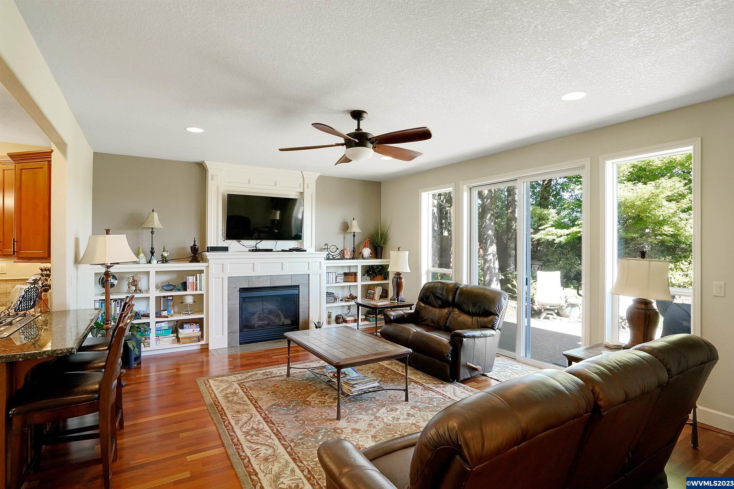 306 Northwest Reed Lane Dallas, OR 97338 - Photo 10 of 42 a living room with furniture a fireplace and a flat screen tv
