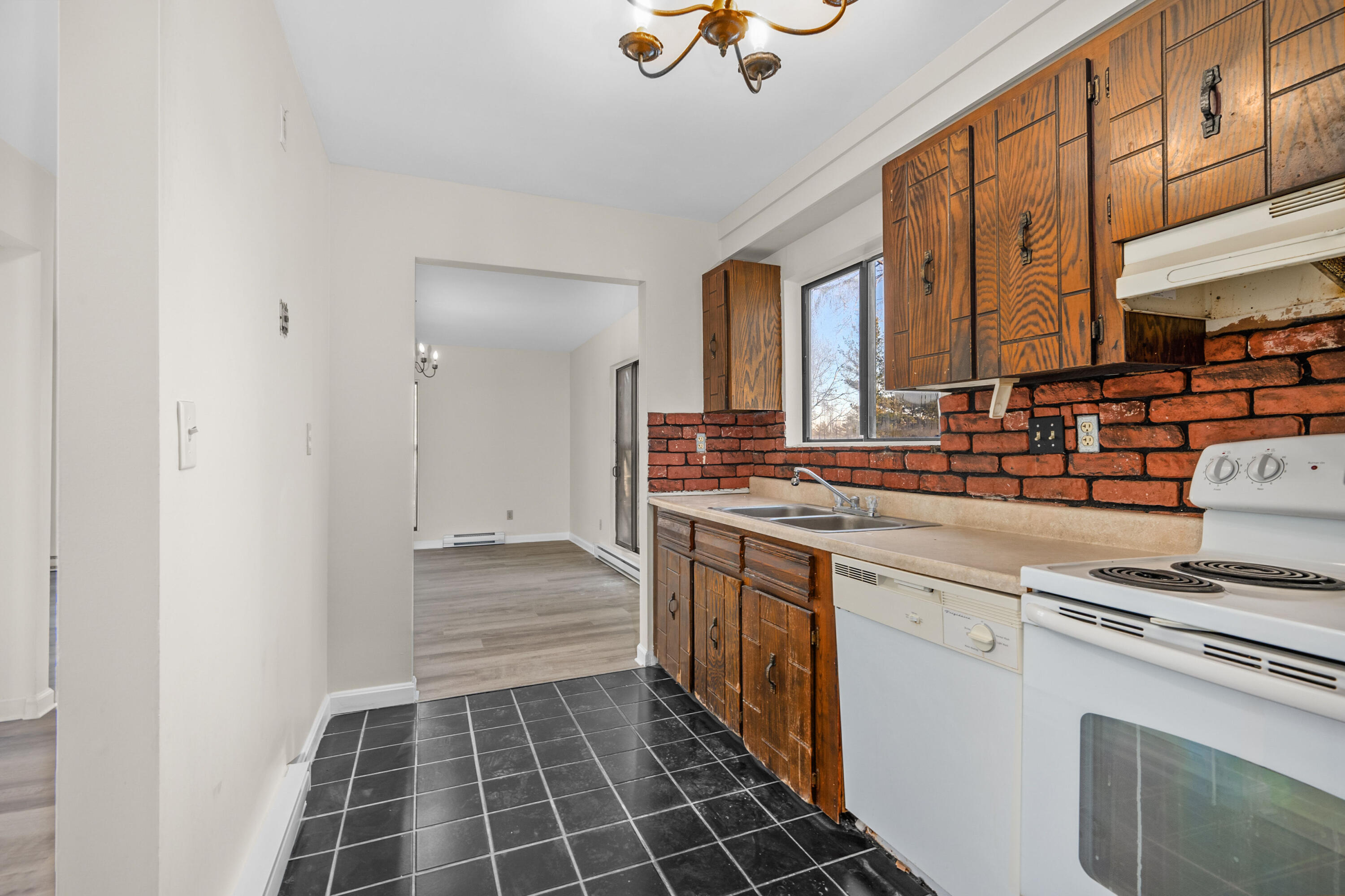 800 Bearses Way, Unit 2NB Hyannis, MA 02601 - Photo 12 of 20 a kitchen with stainless steel appliances granite countertop a sink stove and cabinets