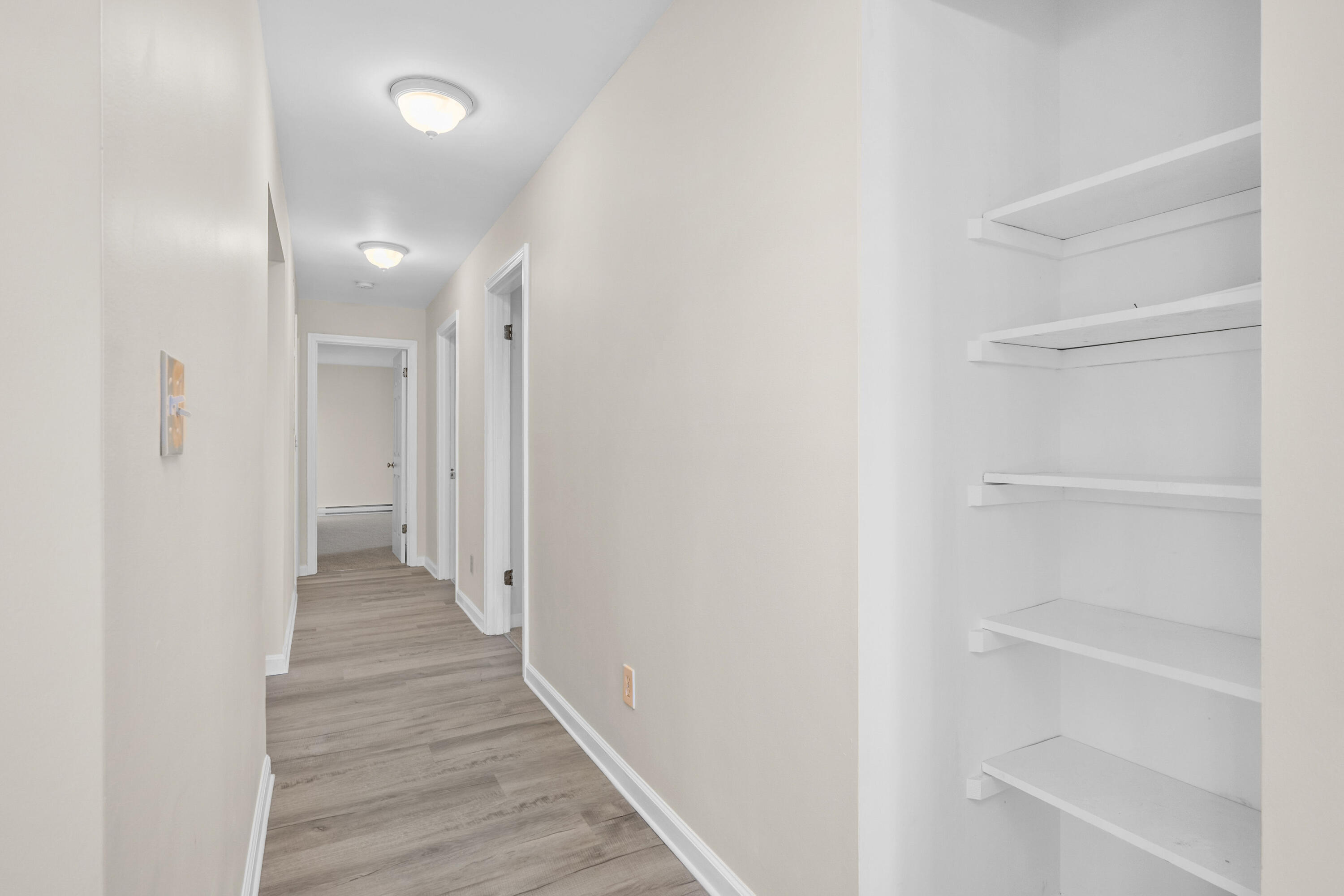 800 Bearses Way, Unit 2NB Hyannis, MA 02601 - Photo 17 of 20 a view of a hallway with wooden floor