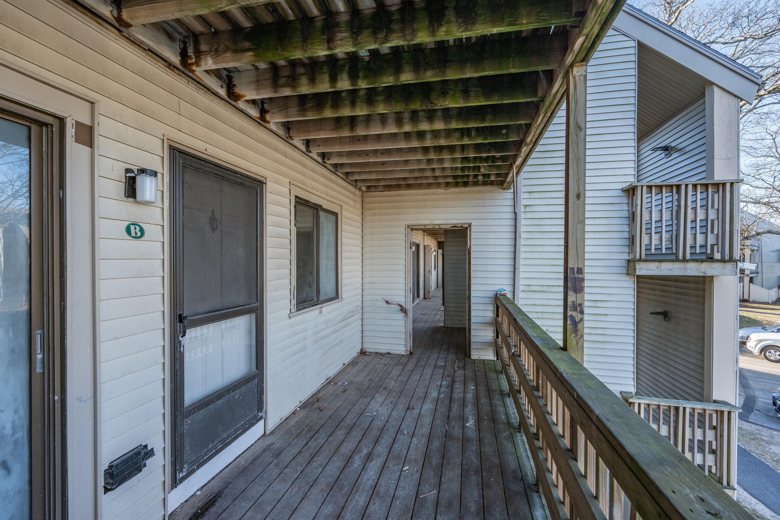800 Bearses Way, Unit 2NB Hyannis, MA 02601 - Photo 4 of 20 a view of a balcony with wooden floor and staircase