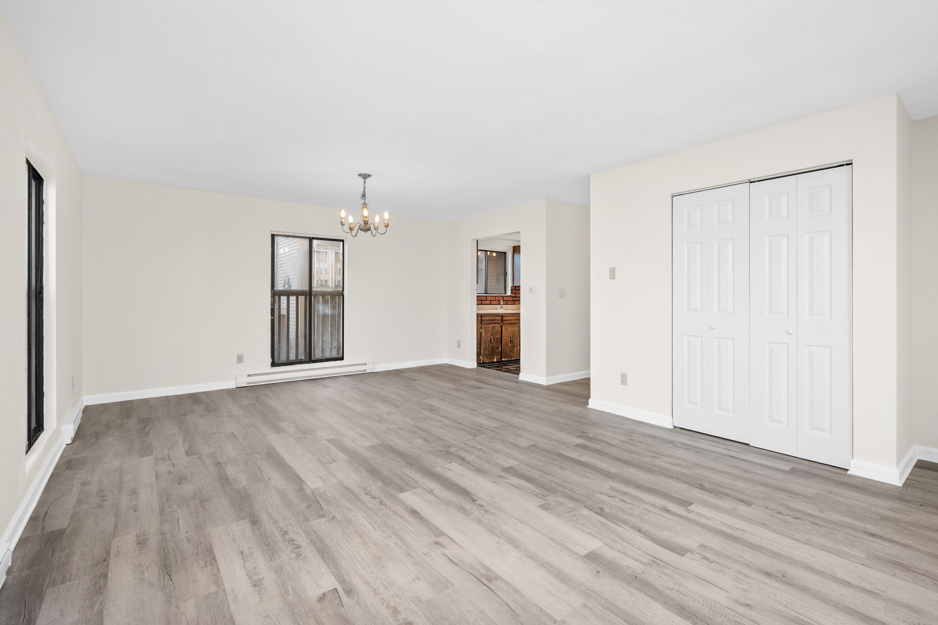 800 Bearses Way, Unit 2NB Hyannis, MA 02601 - Photo 6 of 20 a view of empty room with wooden floor and fan