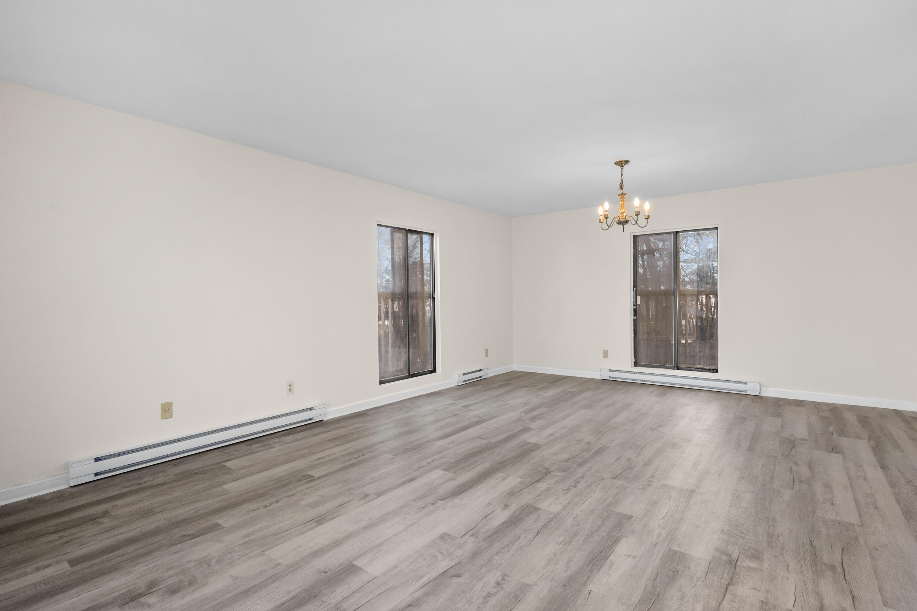 800 Bearses Way, Unit 2NB Hyannis, MA 02601 - Photo 7 of 20 an empty room with wooden floor and window