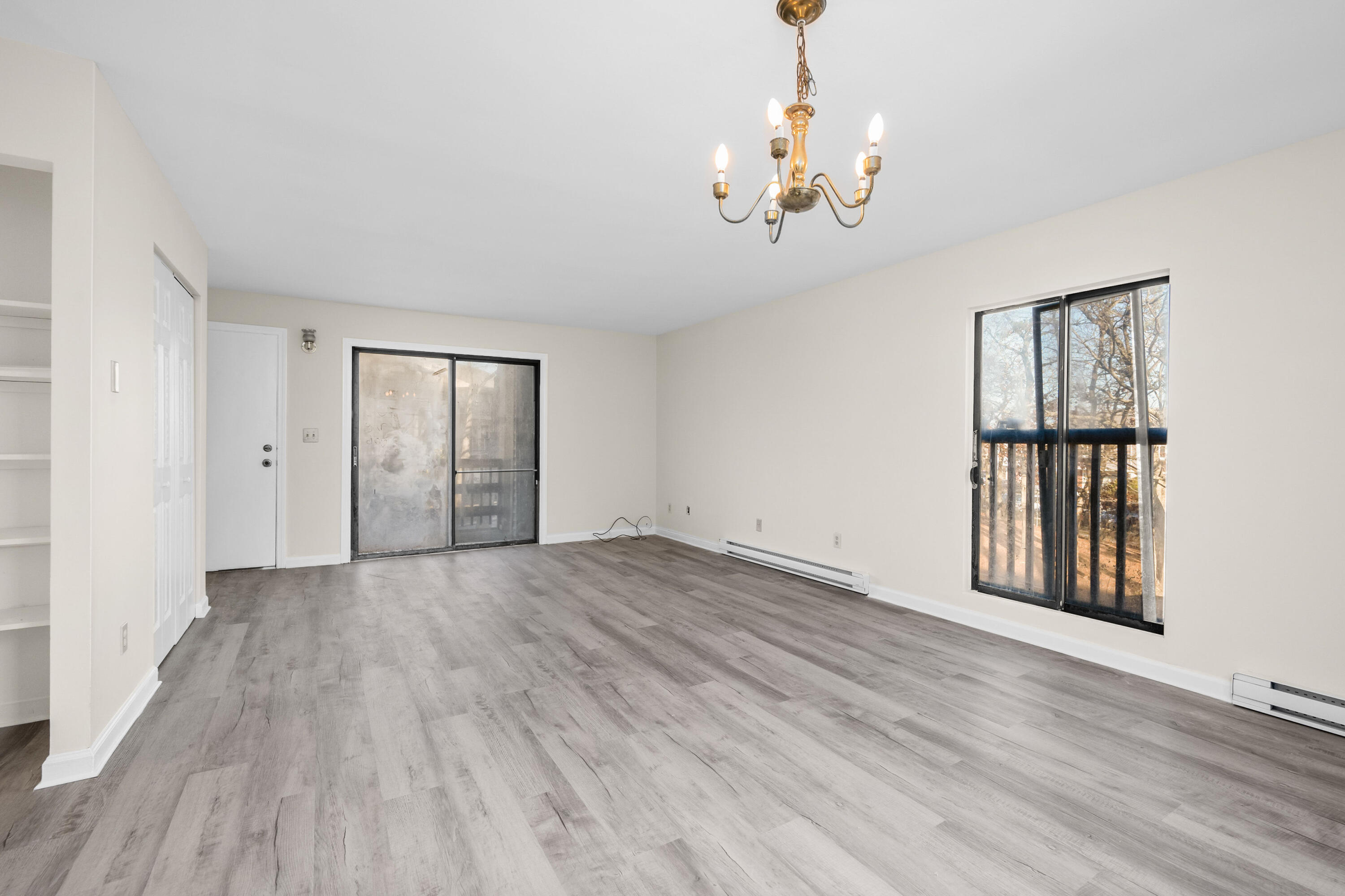 800 Bearses Way, Unit 2NB Hyannis, MA 02601 - Photo 10 of 20 a view of an empty room with wooden floor and a window
