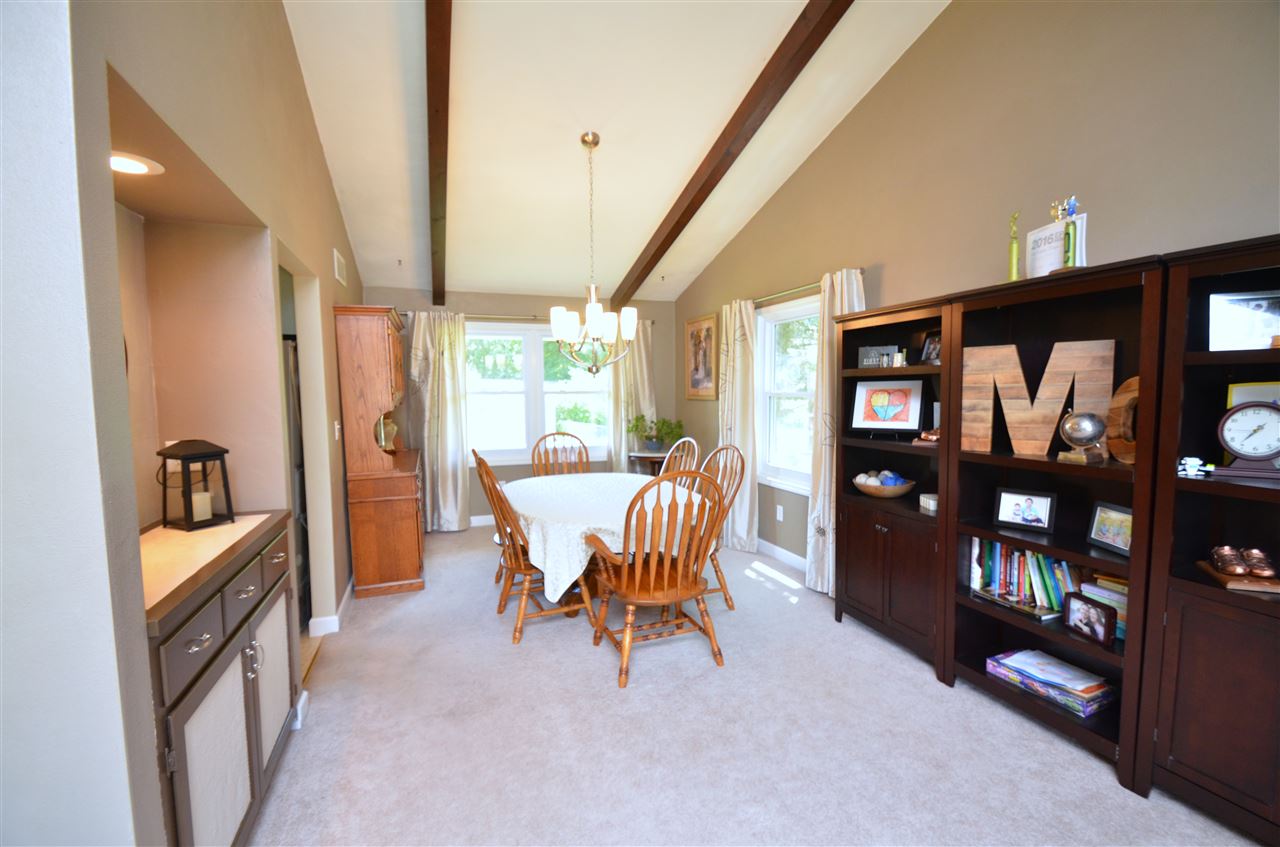 3942 Valerie Road Roscoe, IL 61073 - Photo 4 of 25 a dining room with furniture and a floor to ceiling window