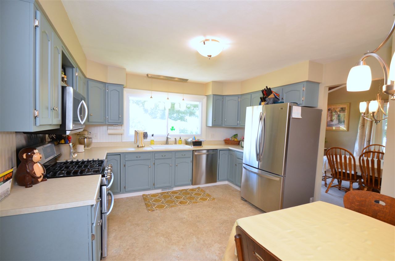 3942 Valerie Road Roscoe, IL 61073 - Photo 8 of 25 a kitchen with a refrigerator and a stove top oven