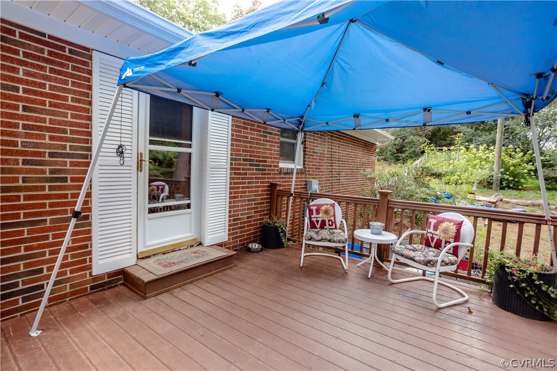 3160 Mountclair Road Chester, VA 23831 - Photo 42 of 50 a view of deck with table and chairs under an umbrella