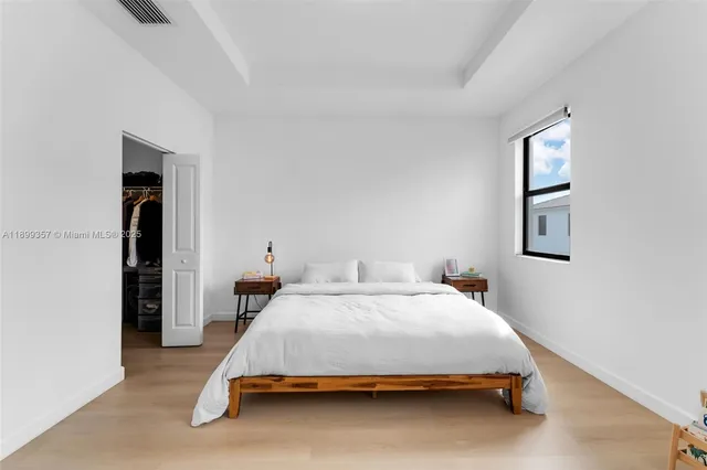 a bedroom with a bed and lamp