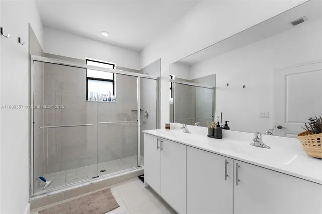 a bathroom with double sink and a mirror