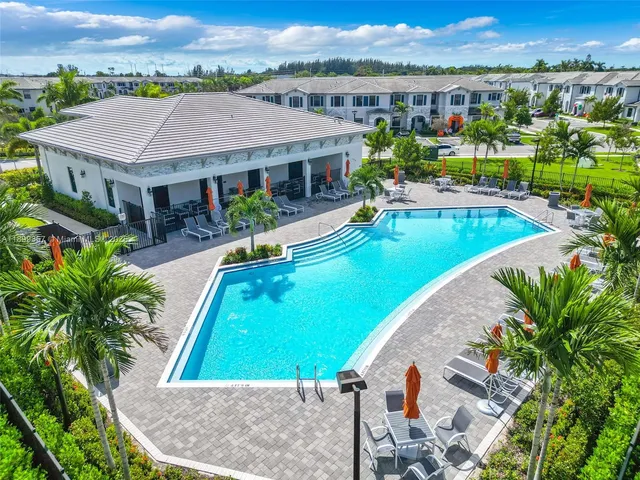 an aerial view of a house with a swimming pool