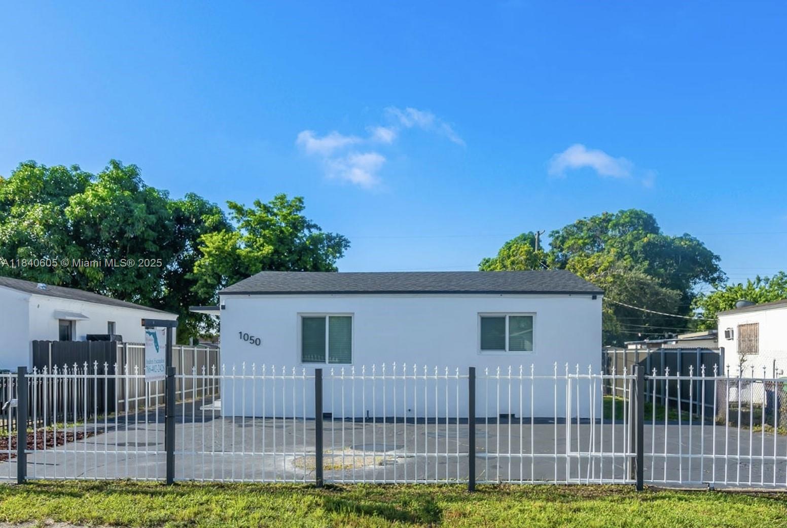 1050 Superior Street Opa-Locka, FL 33054 - Photo 1 of 20 a view of a house with a yard and plants