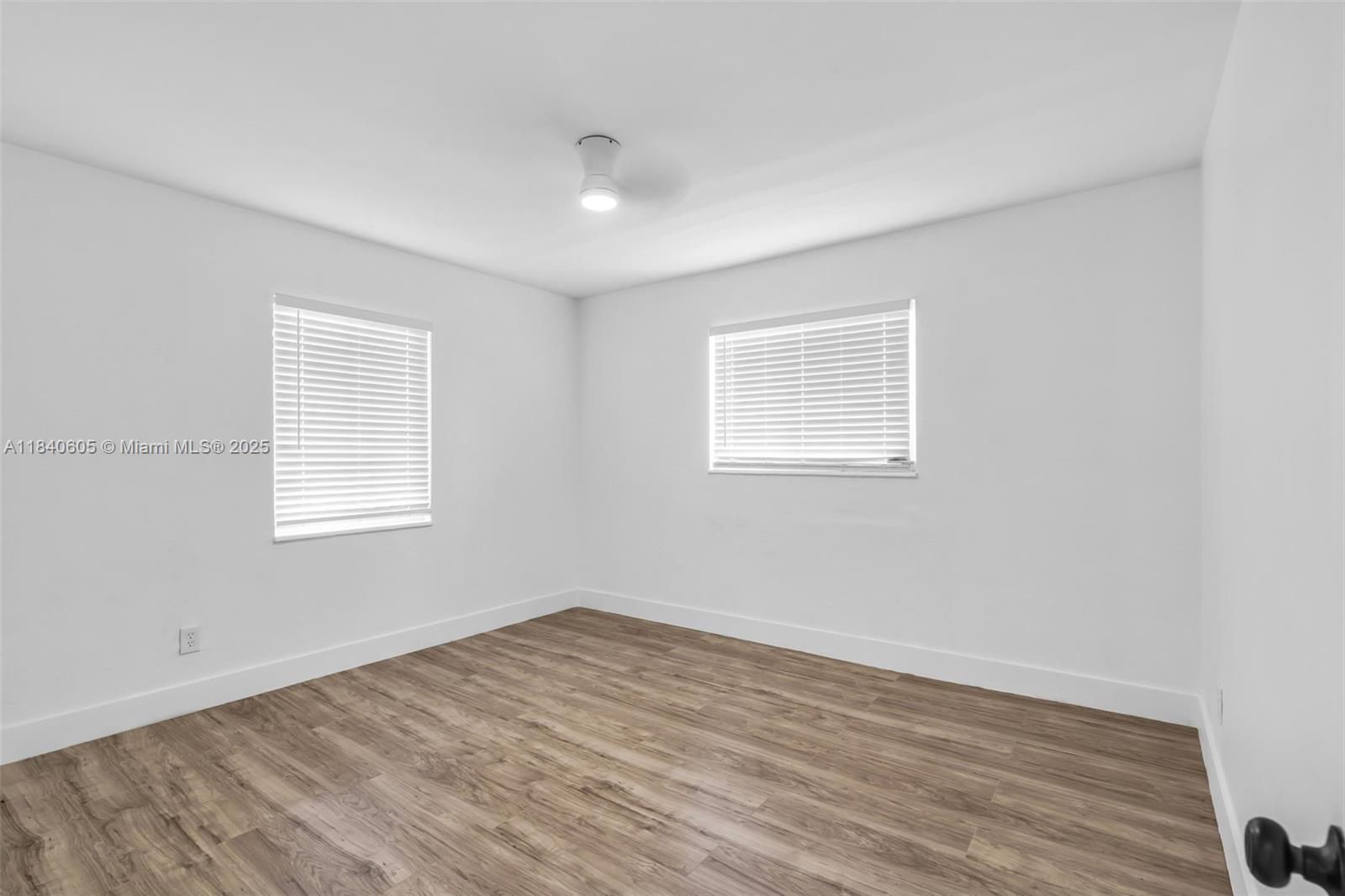 1050 Superior Street Opa-Locka, FL 33054 - Photo 14 of 20 wooden floor in an empty room with a window