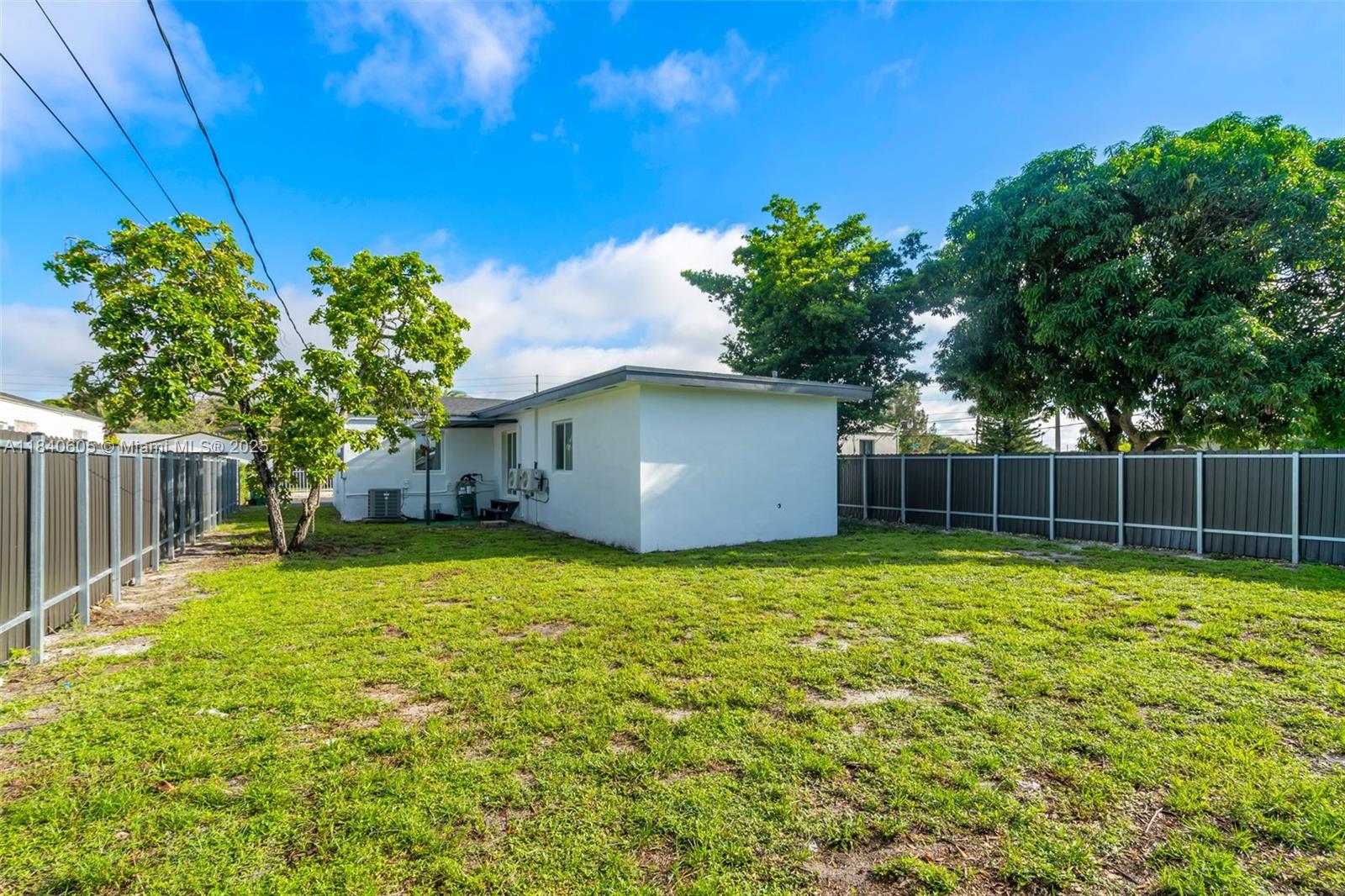 1050 Superior Street Opa-Locka, FL 33054 - Photo 18 of 20 a backyard of a house with lots of plants and tree