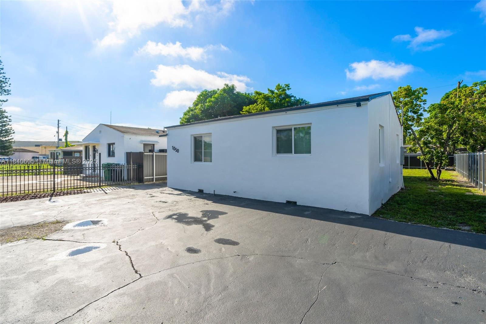 1050 Superior Street Opa-Locka, FL 33054 - Photo 3 of 20 a backyard of a house with wooden fence